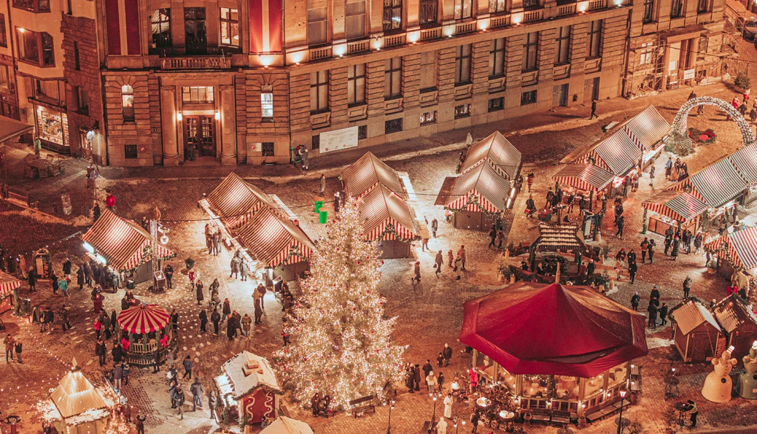 An evening view of a Christmas market in Riga’s Old Town
