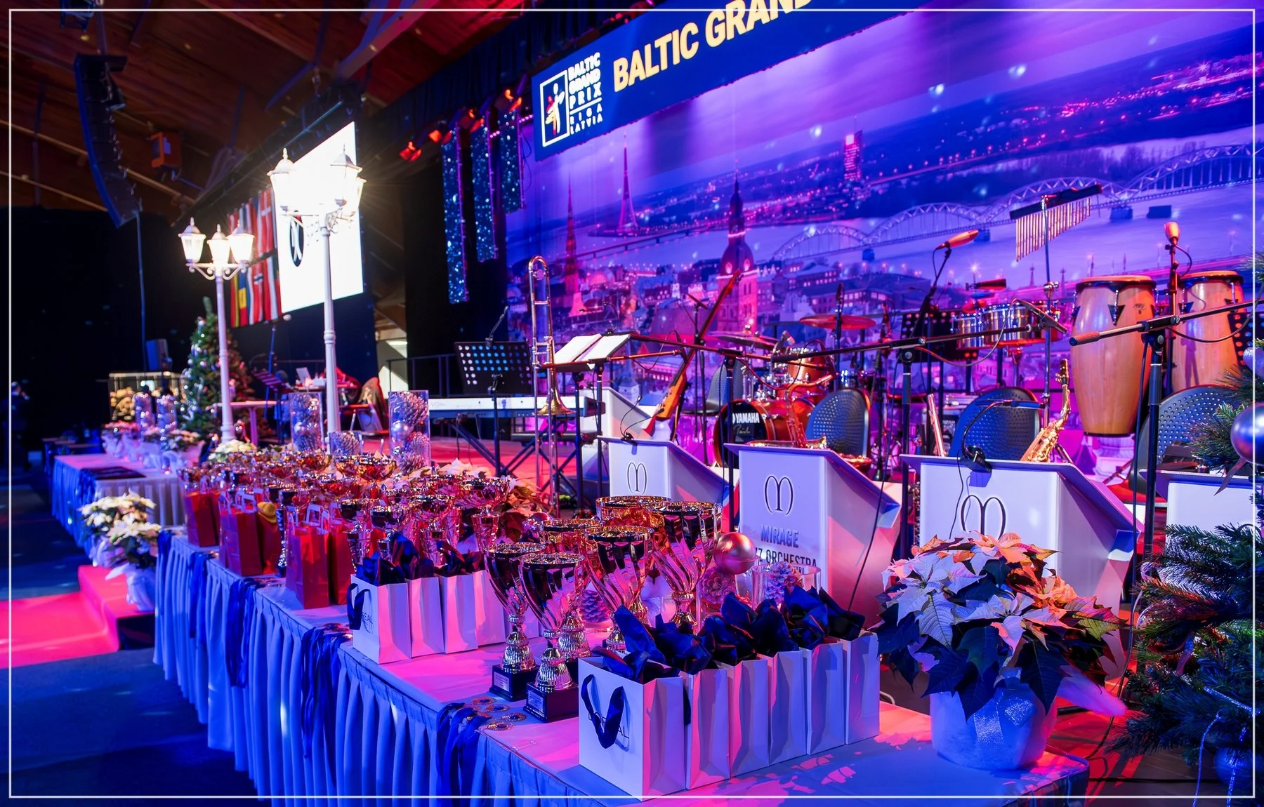 Festival trophies beside the illuminated stage